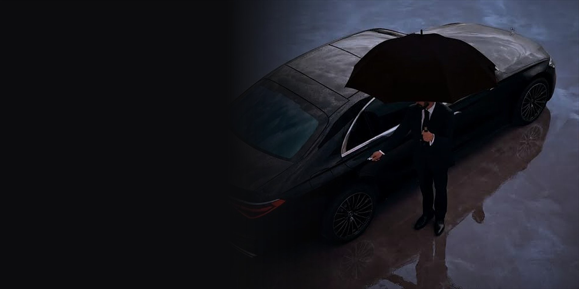 Chauffeur holding an umbrella beside a black Mercedes-Benz S-Class on wet pavement