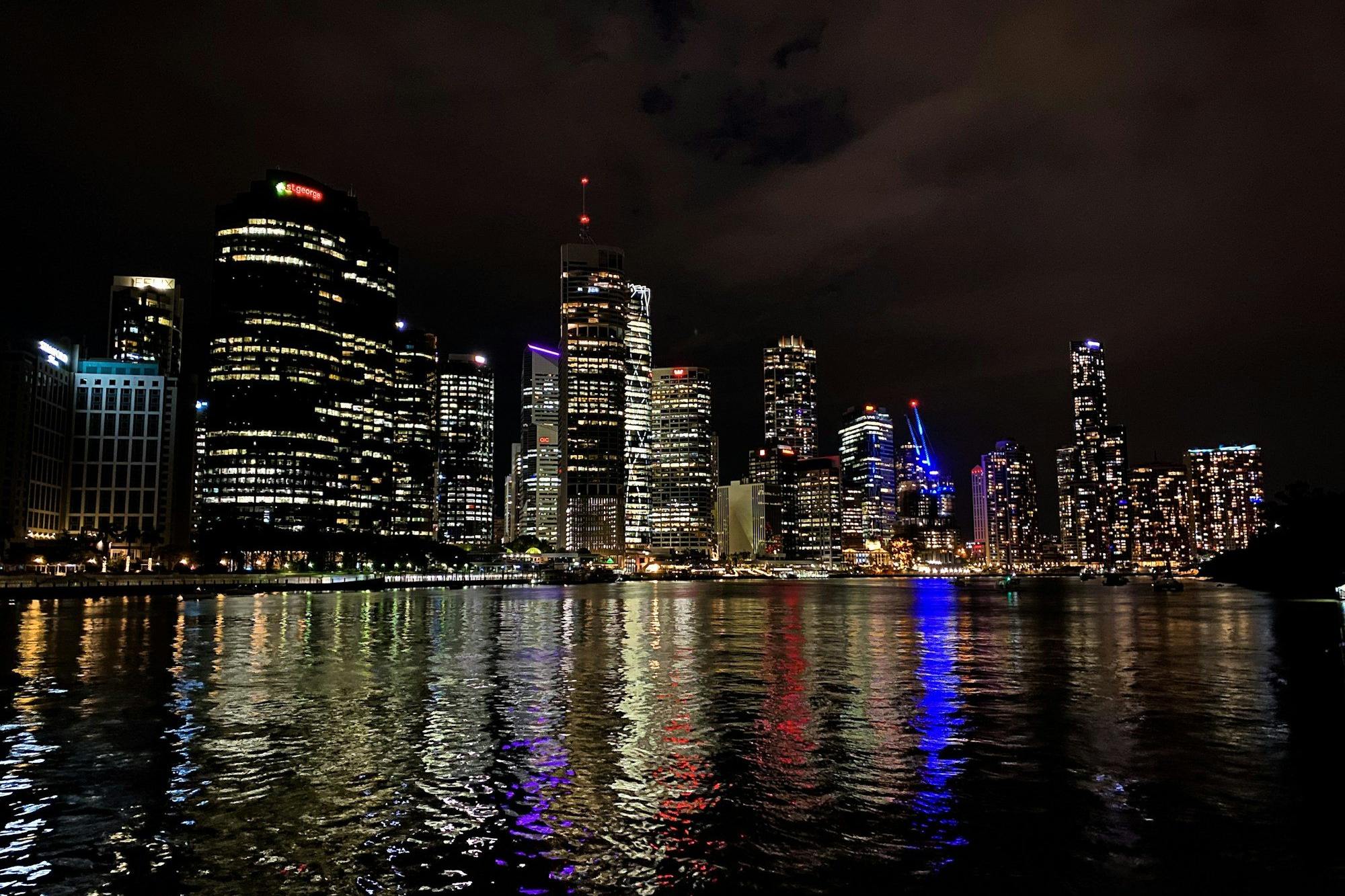 Brisbane airport transfer: Brisbane's city skyline reflected in the river at night